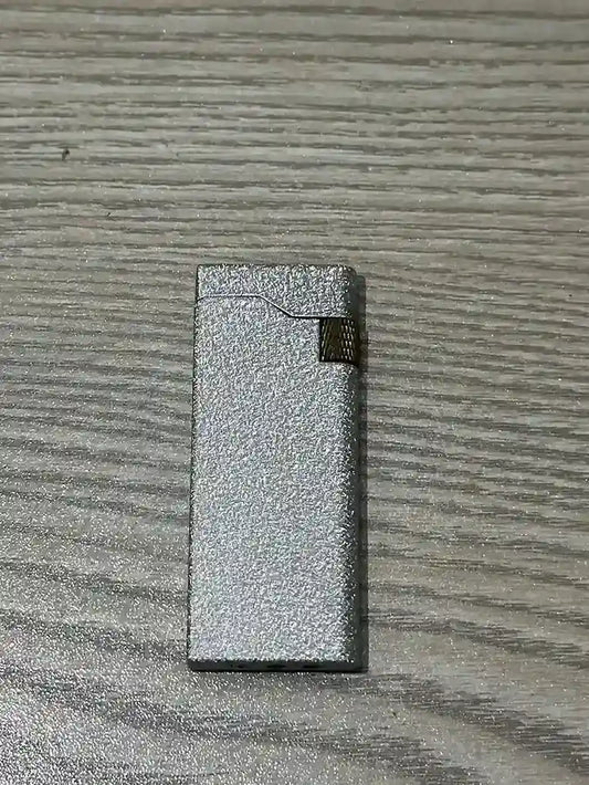 Silver lighter on a textured gray surface