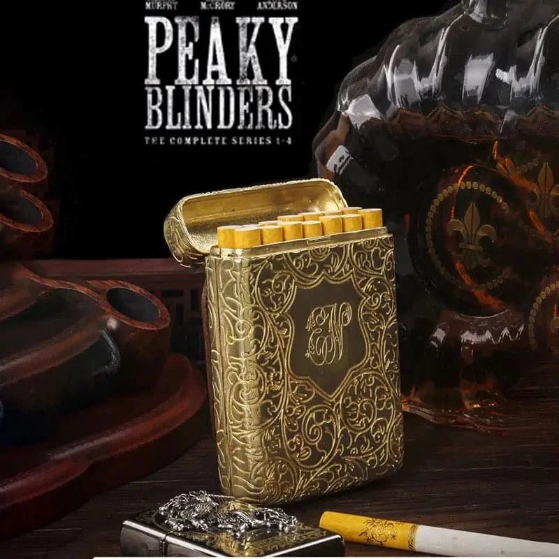Gold cigarette case with decorative design on a dark background featuring 'Peaky Blinders' branding.