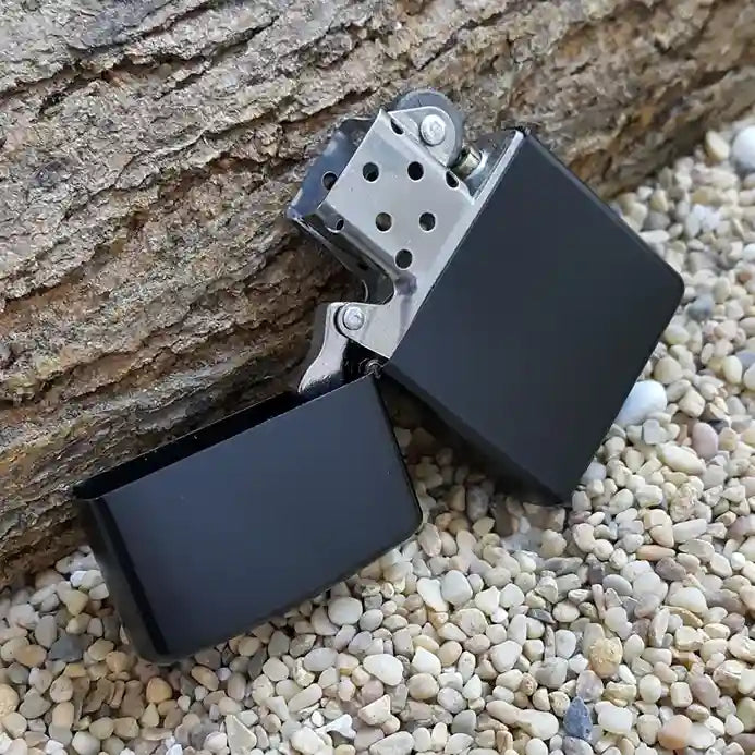 A Black Lighters is placed on the street with the wooden bark