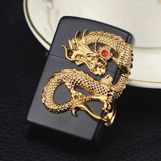 Black lighter with gold dragon design on a dark surface