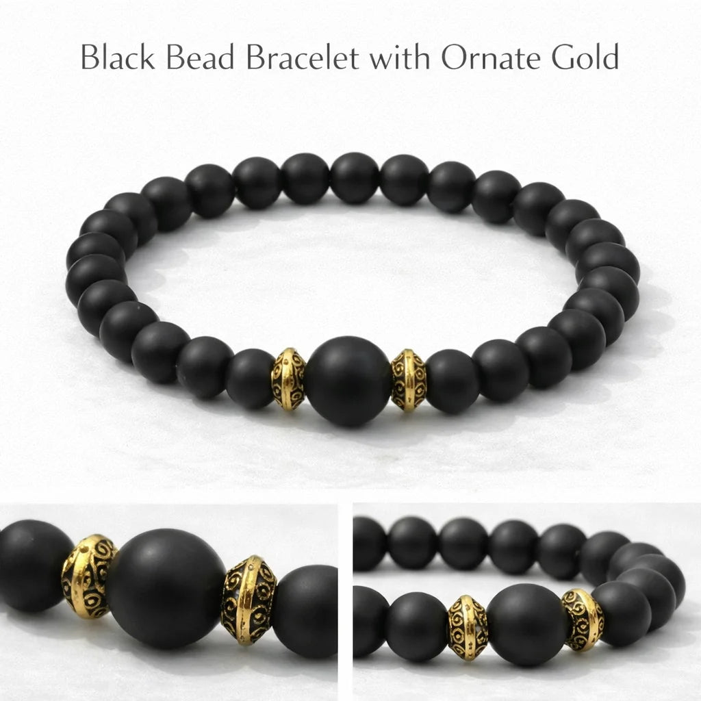 Black bead bracelet with ornate gold beads on a white background