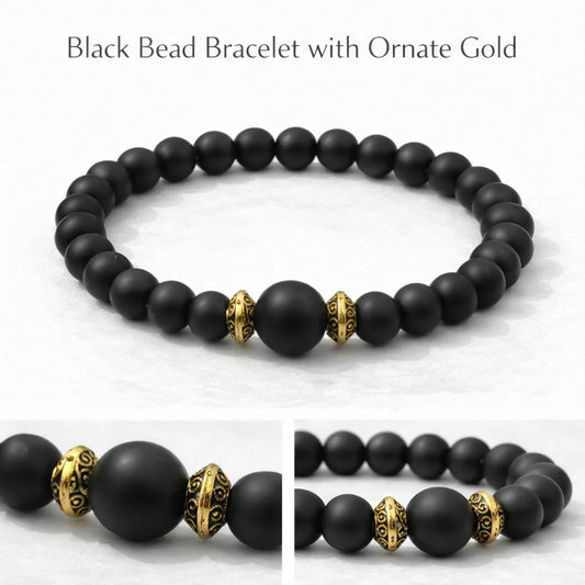 Black bead bracelet with ornate gold beads on a white background