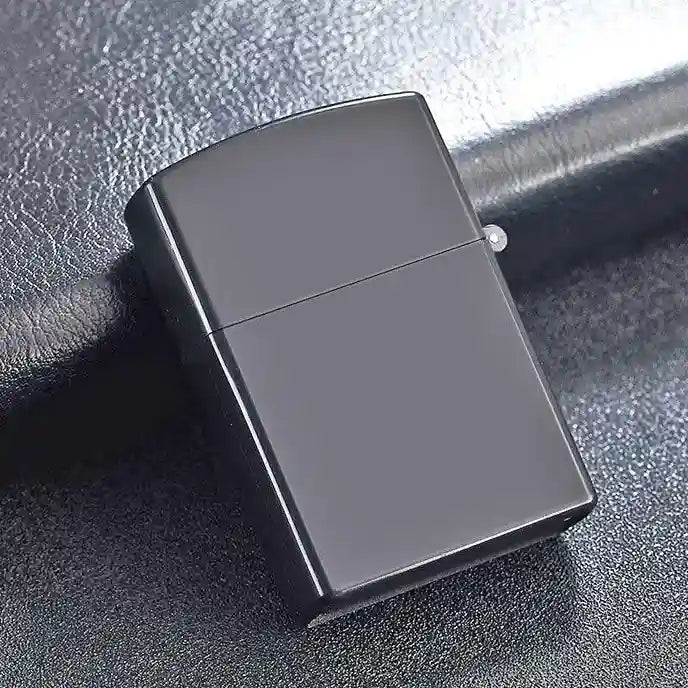 Black and silver zippo lighter on a textured surface