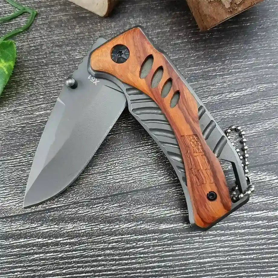 knife on grey background with half open x61 written on blade