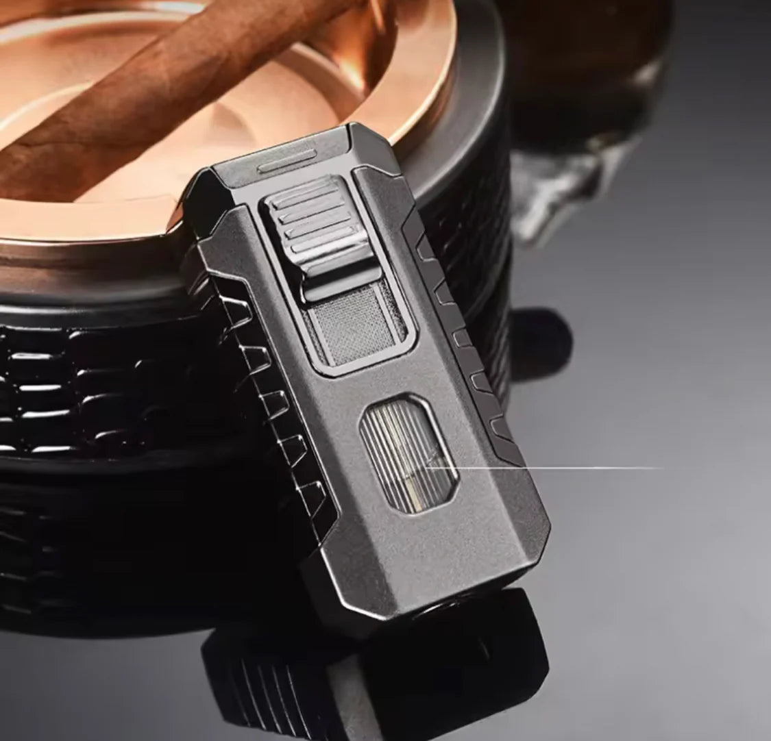 Close-up of a black lighter with metallic accents on a reflective surface.