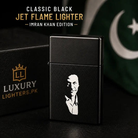 A black jet flame lighter with a white portrait engraving, shown next to its branded black box. The lighter has a textured black finish and features a white silhouette of Imran Khan.
