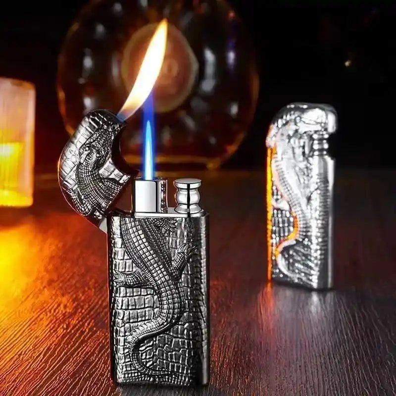 Silver lighter with dragon design on a wooden surface with a blurred background