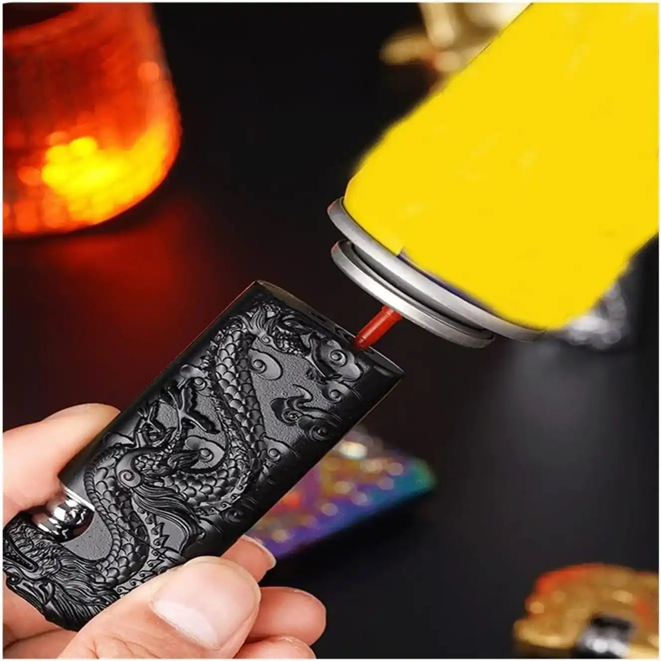 Person using a lighter to light a dragon-patterned lighter