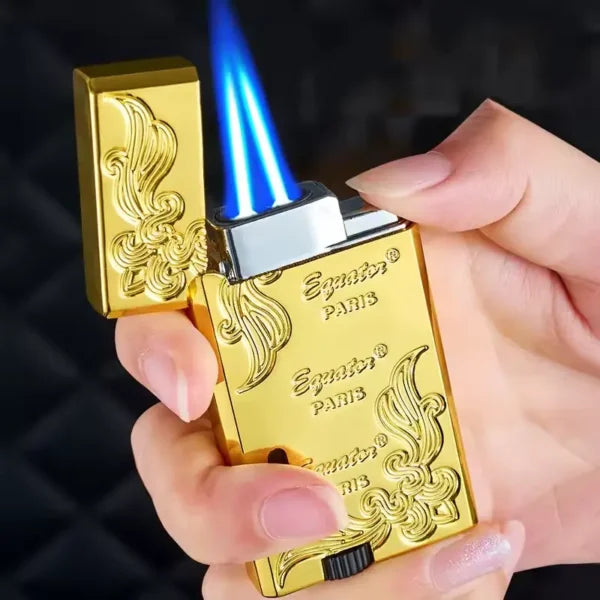 Gold lighter with blue flame held by a hand against a dark background