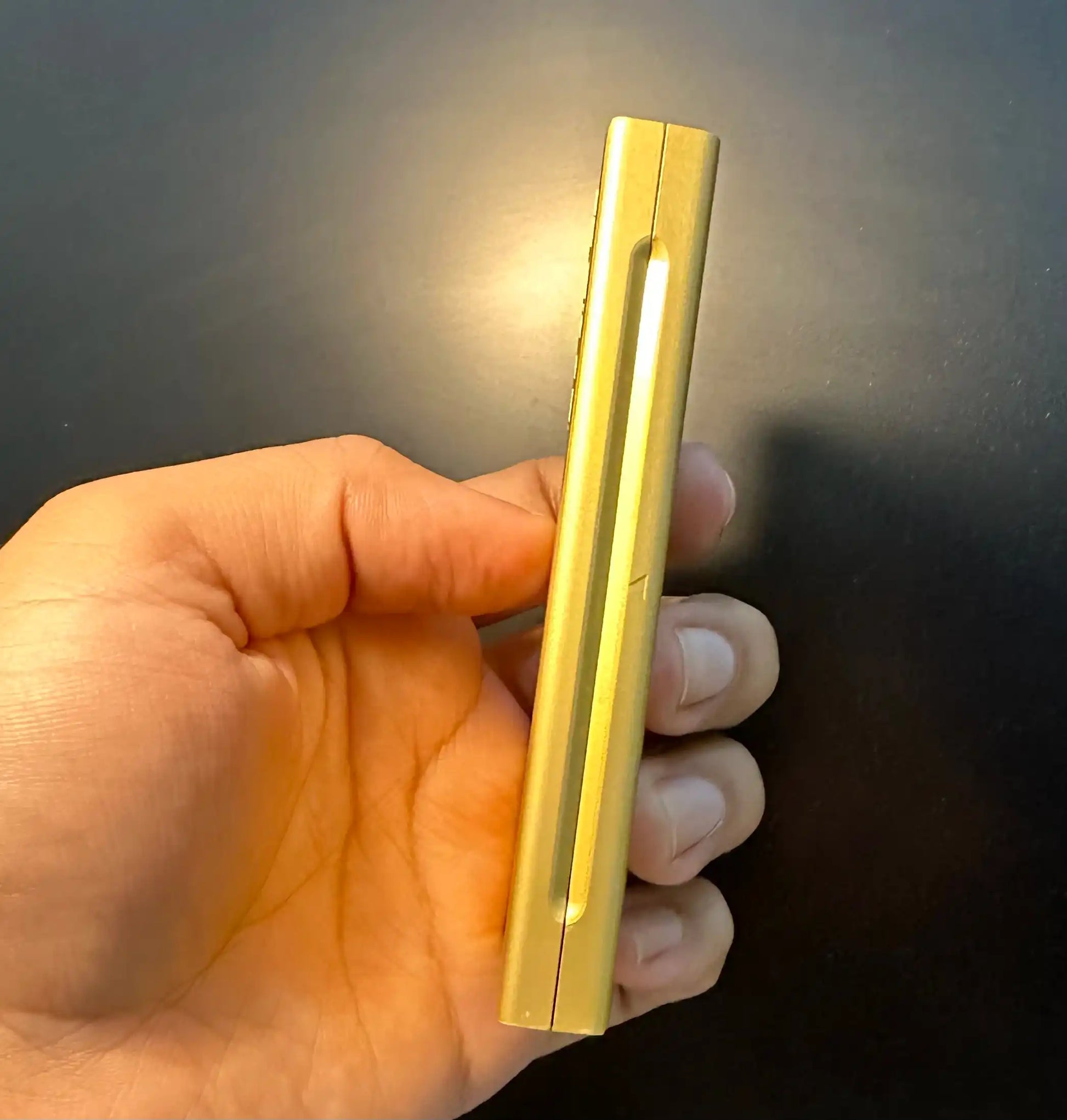 Esse Special Gold Edition cigarette pack held by a hand with a dark background