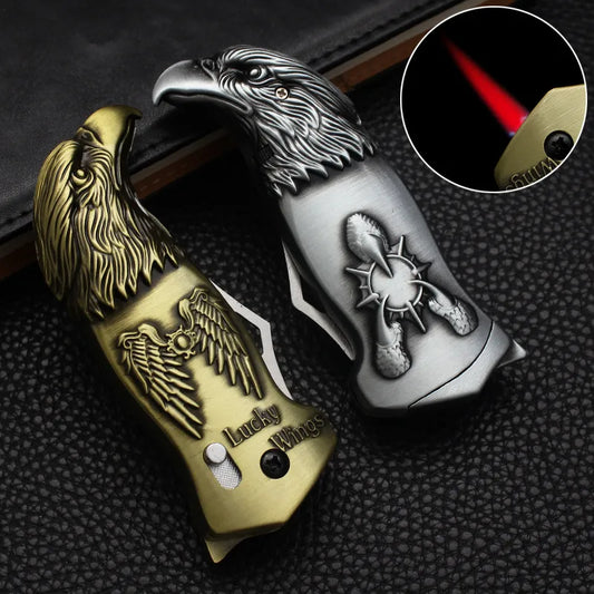 Two metallic eagle-shaped lighters on a textured surface with a close-up of one lighter's flame.
