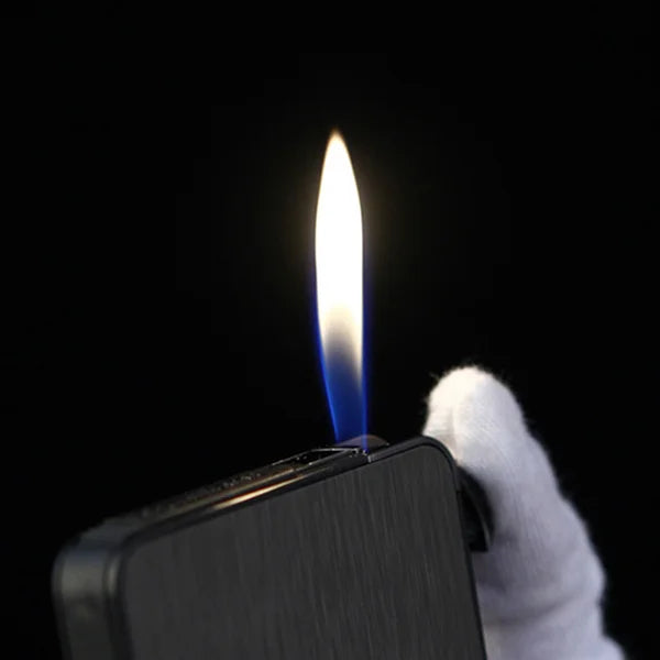 Lighter with a lit flame held by a gloved hand against a black background