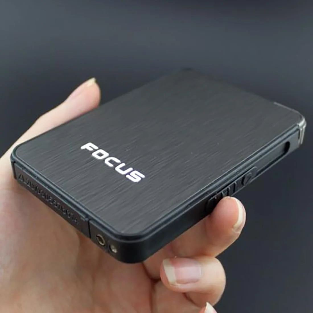 Person holding a black FOCUS Cigarette Case product JD-YH003 on a dark background