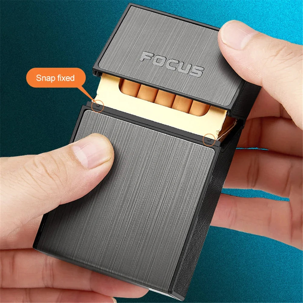 Person holding a black cigarette case with 'FOCUS' branding and snap mechanism.
