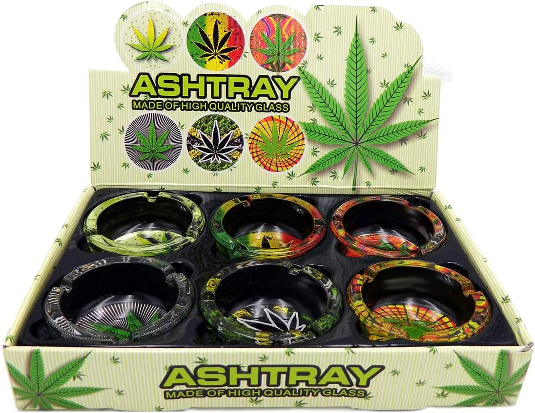 Box of glass ashtrays with colorful leaf designs on a white background