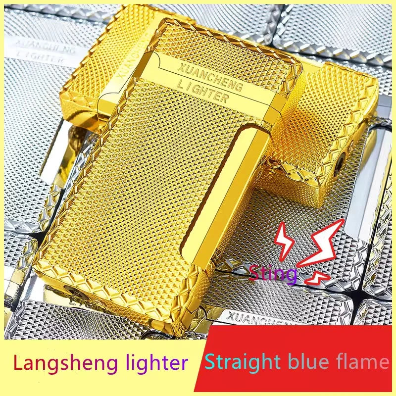 Gold lighter with textured surface on a metallic background