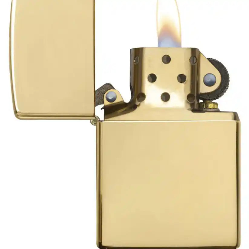 Gold lighter with flame on a white background