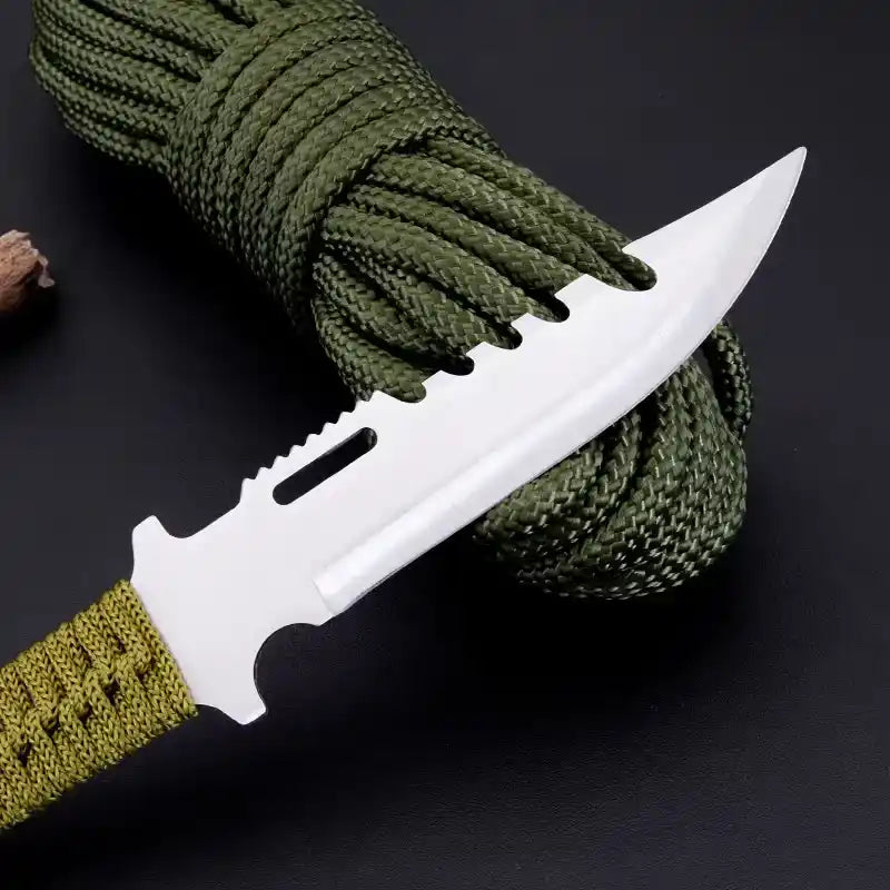 Knife with a green handle and white blade on a dark background