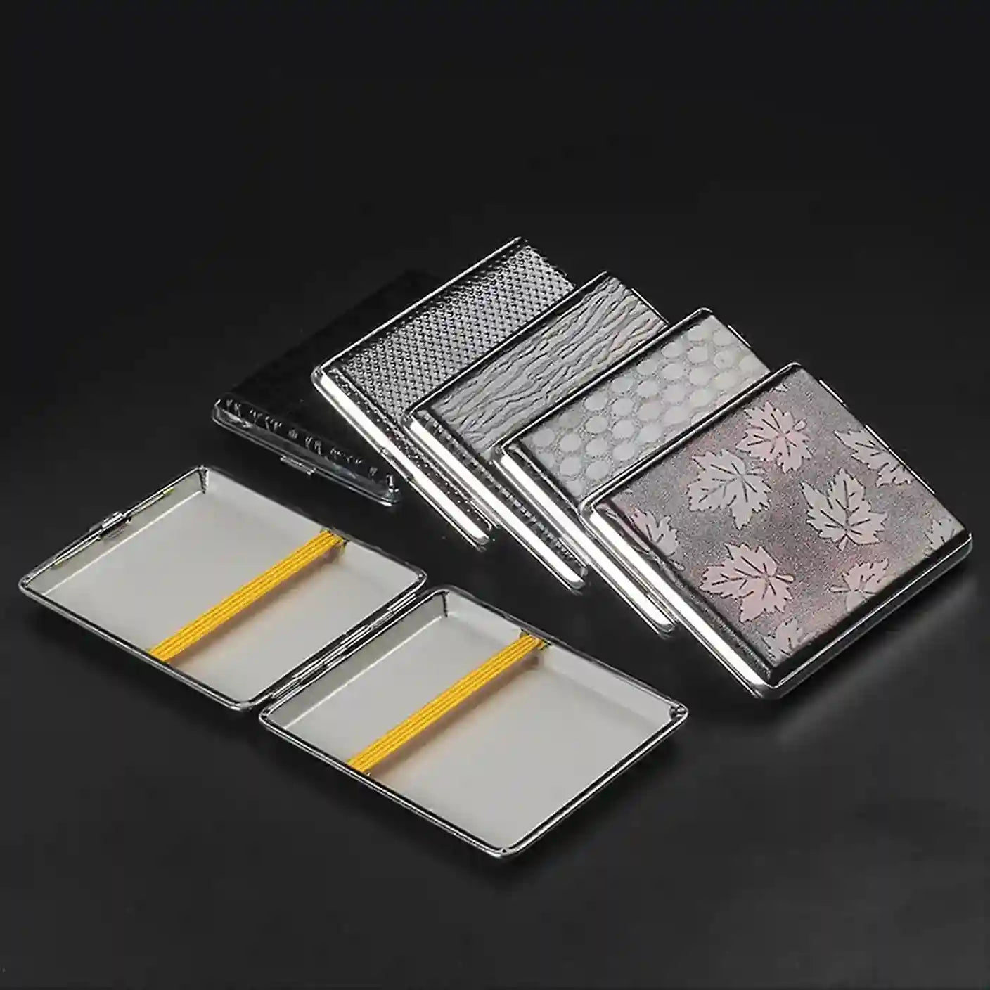 Set of black textured cig case on a white background