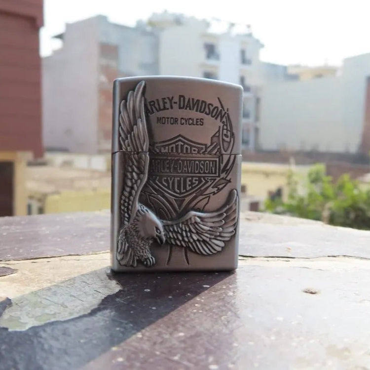 Harley Davidson lighter on a rooftop with buildings in the background