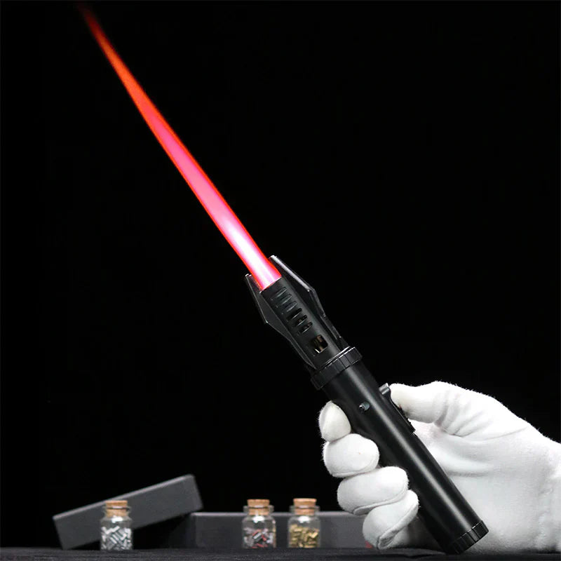 Hand holding a black laser pointer with red light on a dark background
