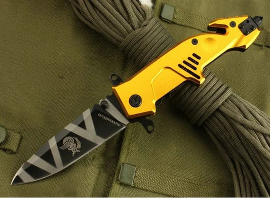 Yellow folding knife with a Union Jack blade design on a green fabric background
