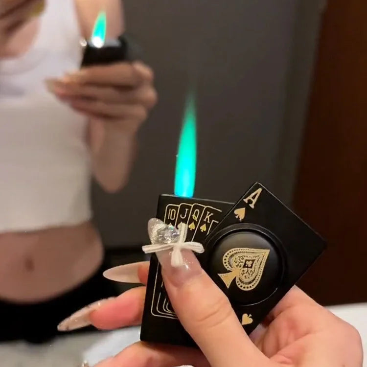 Hand holding a deck of cards with a lighter and a ring, blurred background