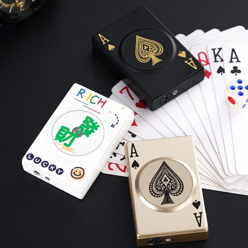 Playing cards with a focus on a black lighter and cards displaying 'RICH' and '2A'.