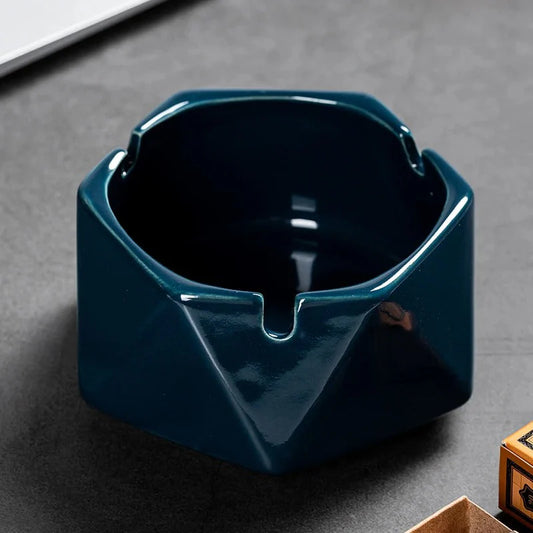 Blue ceramic ashtray on a gray surface