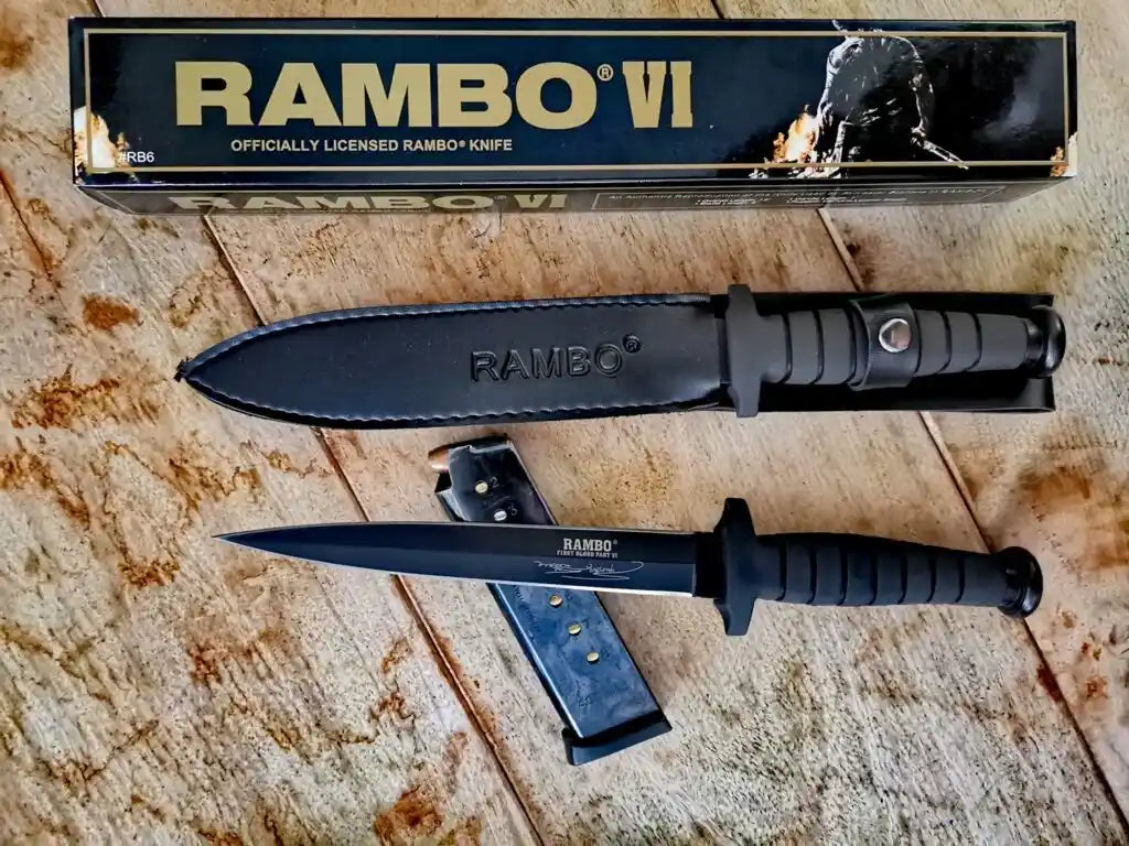 Rambo knife with sheath and branded box on a wooden surface