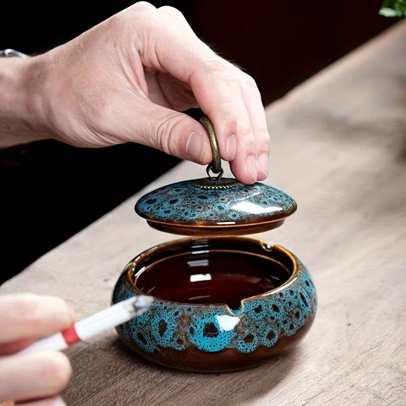 Ceramic Ashtray with decorative lid on a wooden surface