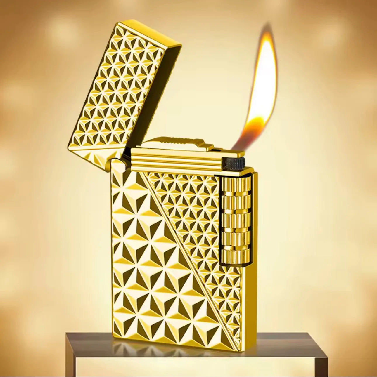 Gold lighter with geometric pattern on a reflective surface