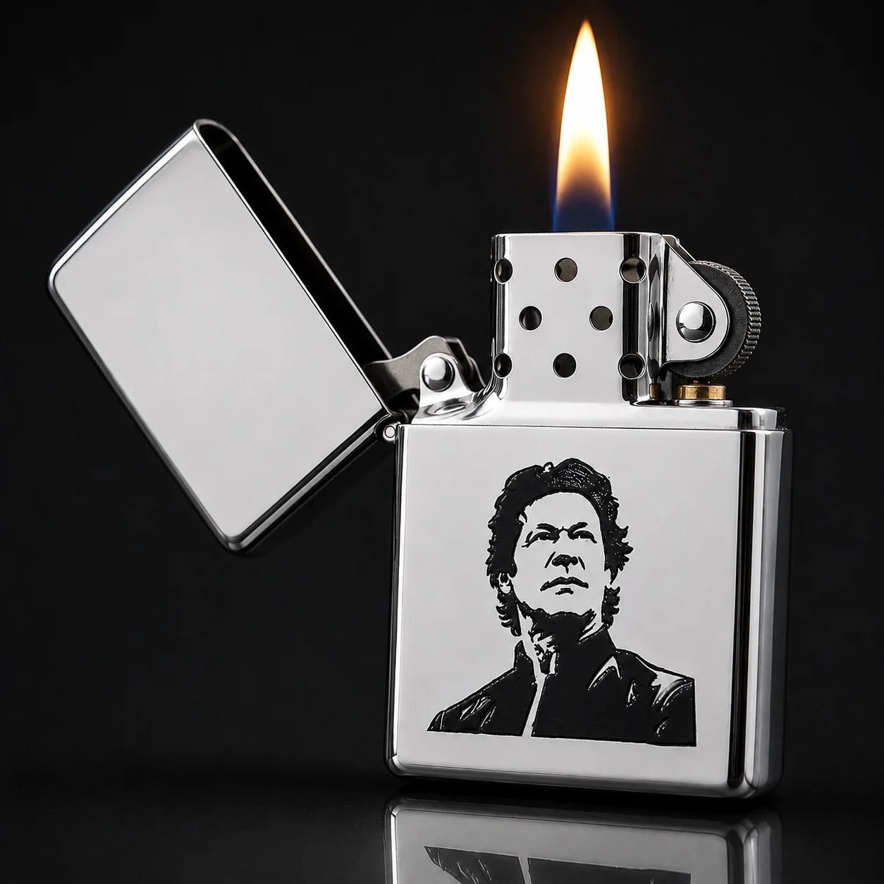 A polished silver metal lighter with a black-and-white portrait engraving on the front, shown open with a flame lit against a dark background.