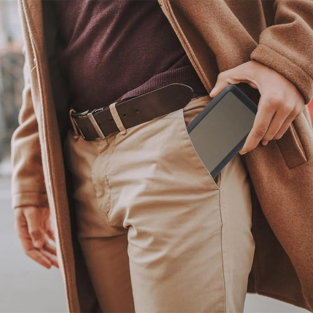 Person wearing a brown coat and holding a cigarette case with a blurred background