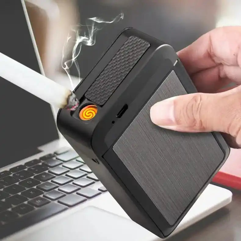 Person using a portable cigarette case with a visible flame in front of a laptop.