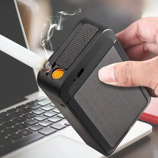 Person using a portable cigarette case with a visible flame in front of a laptop.