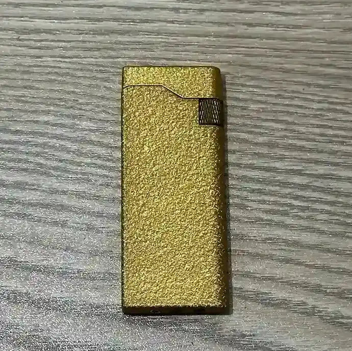 Gold lighter on a wooden surface