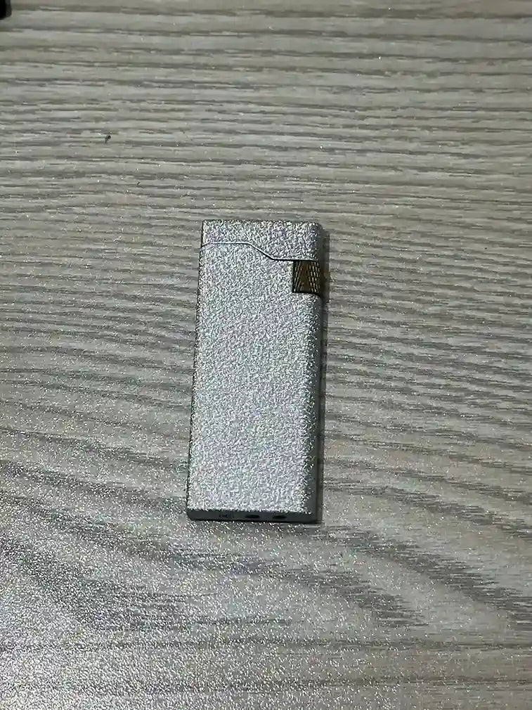 Small rectangular metallic Lighter on a textured surface