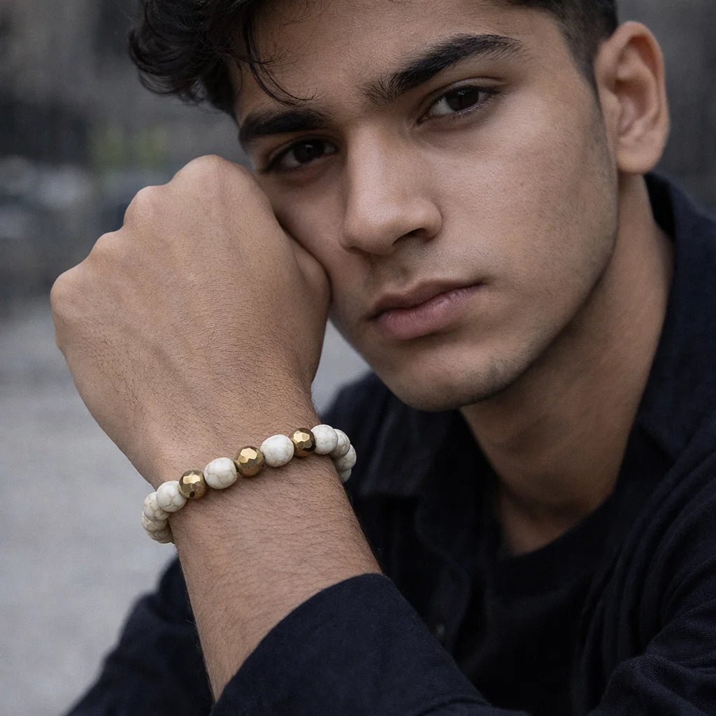 Man wearing a beaded bracelet on his wrist with a blurred background