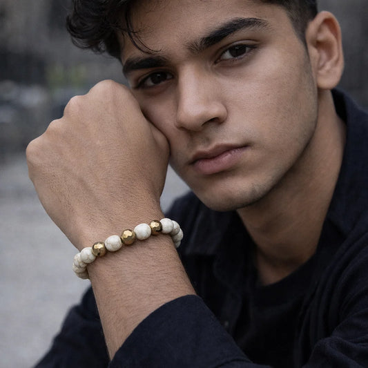 Man wearing a beaded bracelet on his wrist with a blurred background