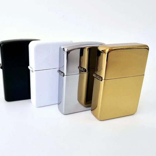 Four Zippo lighters in black, white, silver, and gold on a white background