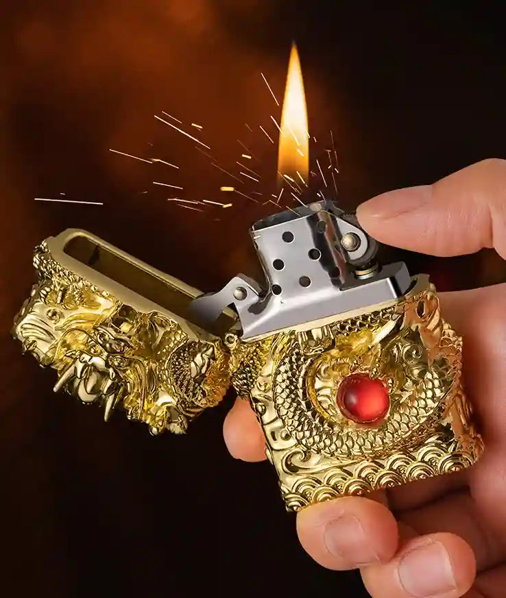 Decorative gold lighter being ignited with a flame against a dark background