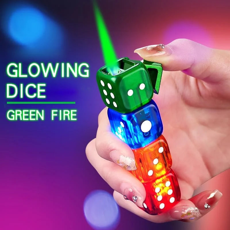 A hand holding a lighter of four glowing translucent dice in green, blue, orange, and red, with a bright green laser-like beam shooting out from the top die. Text on the left reads 'GLOWING DICE GREEN FIRE' against a colorful purple and blue bokeh background.