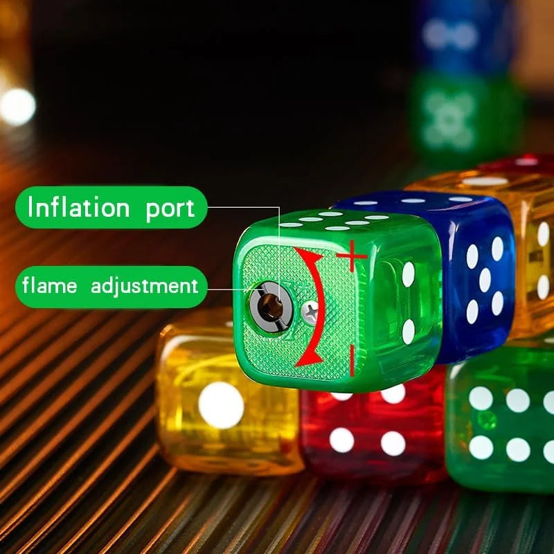 A close-up of a translucent green die lighter with a visible inflation port and flame adjustment screw, overlaid with green labels reading 'Inflation port' and 'flame adjustment.' Other colorful dice are blurred in the background on a dark surface.