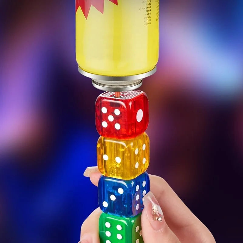 A hand holds a lighter of translucent colored dice blocks topped with a yellow cylindrical container, set against a blurred multicolored background.